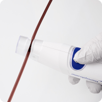 close-up of the top of the sealer as it seals a tube containing blood